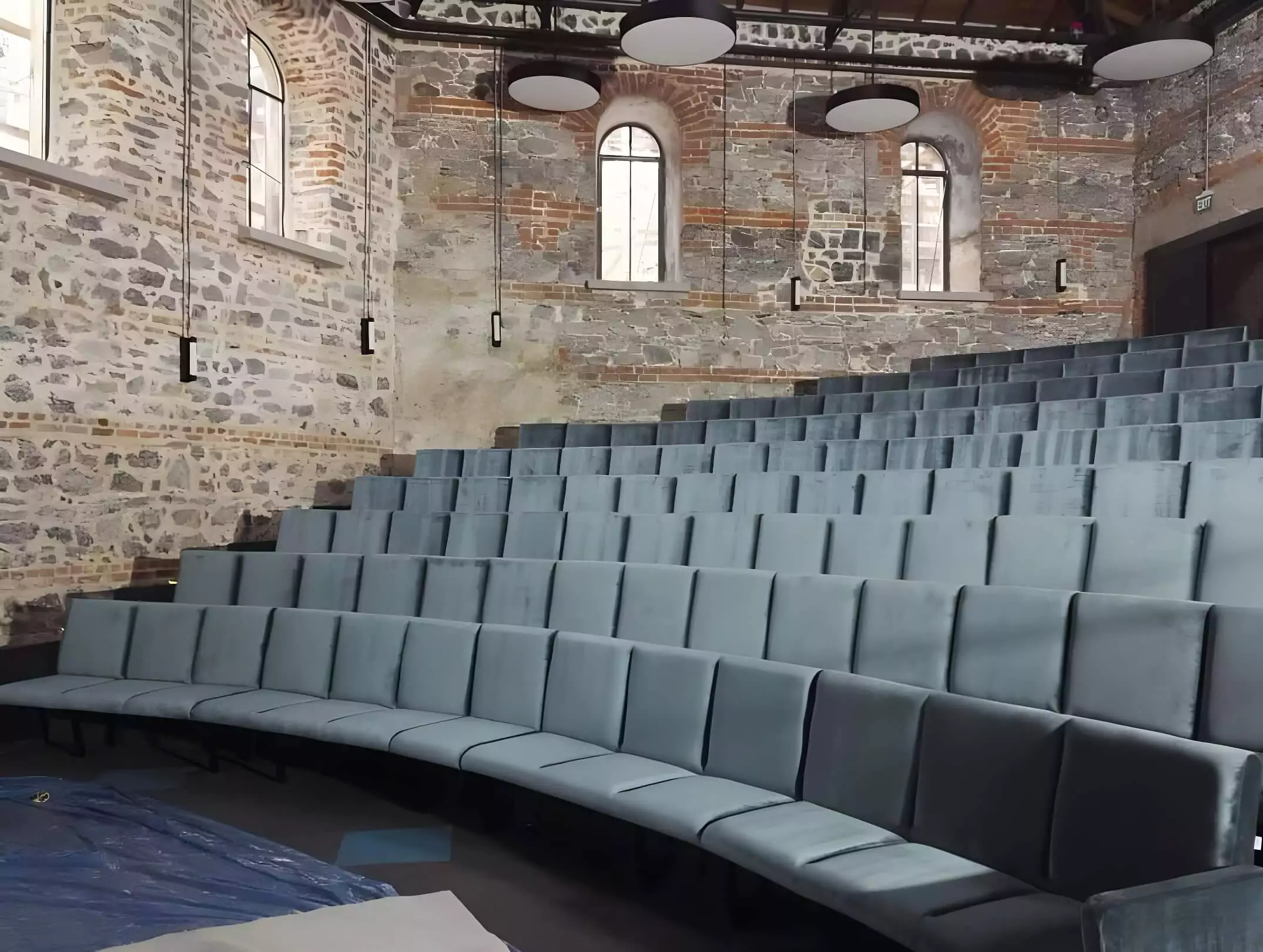 The theater seating in this project combines comfortable upholstery with long-lasting mechanisms, designed to provide superior support for auditoriums and conference halls hosting extended events. Image