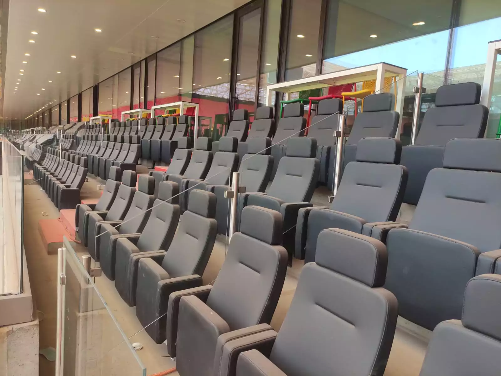 In this project, our VIP stadium seating offers luxury features such as built-in charging ports and plush synthetic leather, tailored for exclusive sections of sports venues. Image