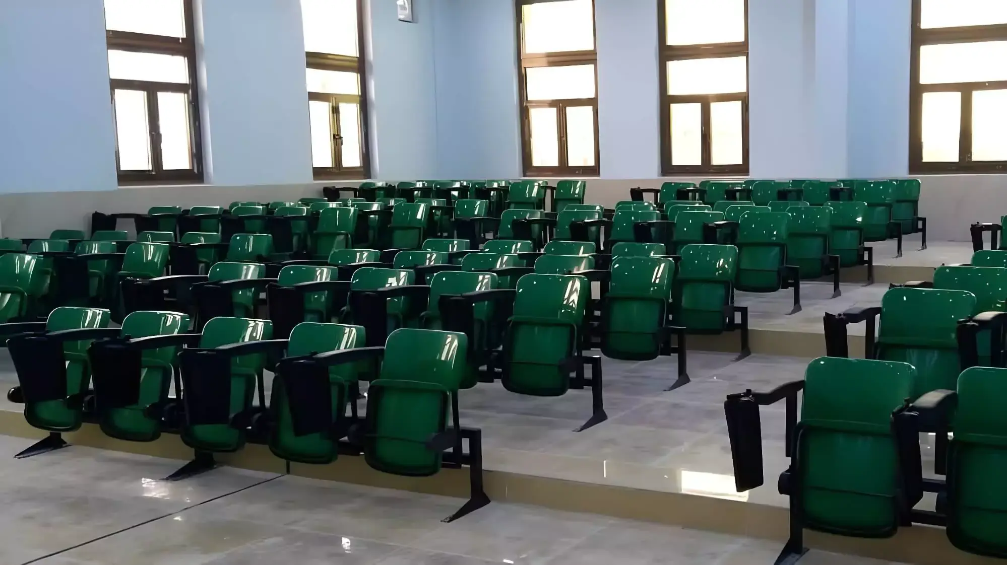 Stadium seating installation featuring foldable tip-up chairs with weather-resistant materials, optimized for efficient crowd flow and high-capacity arenas. Image