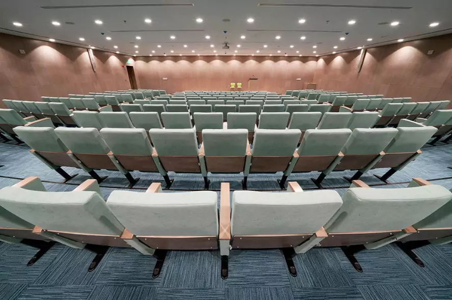 This auditorium seating project emphasizes our commitment as a leading supplier, providing ergonomic chairs with fire-retardant fabrics and sturdy construction, ideal for conference rooms and theater spaces. Image